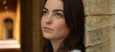 Example image showing portrait of woman leaning on a wall, looking upper left