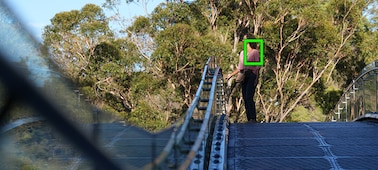 Photo of a woman standing on a bridge