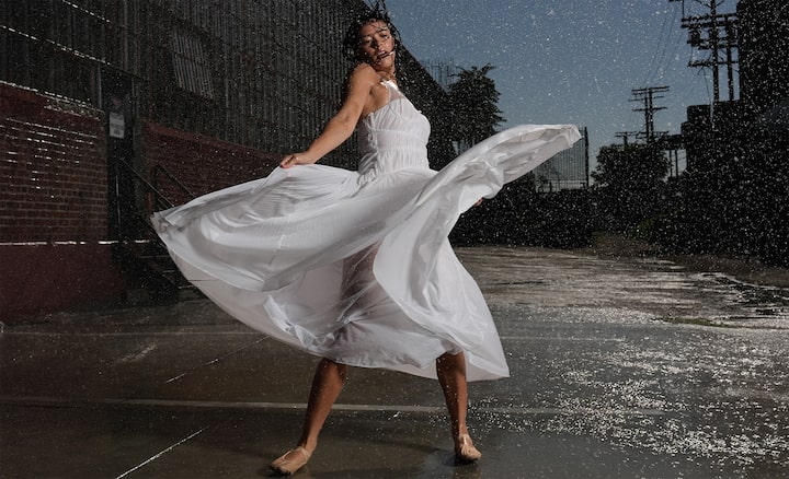 Example image of a woman dancing in the rain