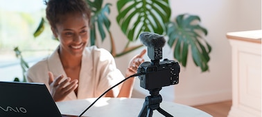 Photo of a woman live streaming with the camera