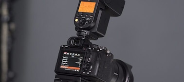 Rear view of the camera with an external flash mounted on top