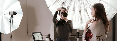 Image of a female photographer and a female model in a photography studio