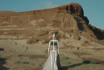 Example image showing a woman walking on sand, with human pose estimation recognising her head and body